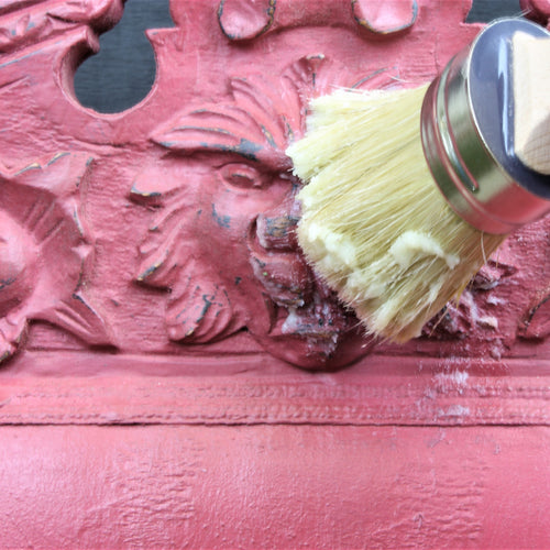 clear wax being applied to a painted chair